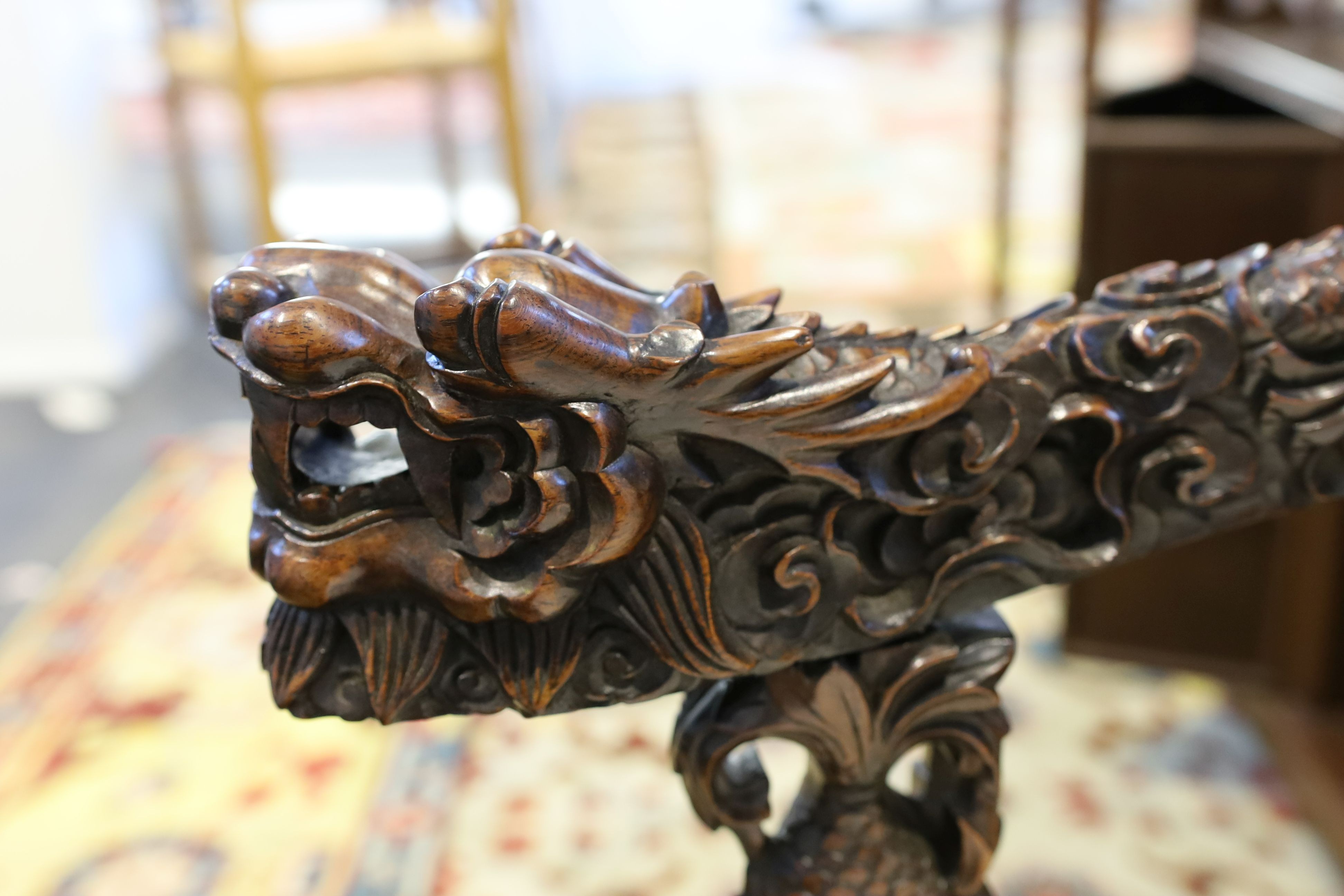 A good Chinese hardwood ‘dragon’ throne armchair, c.1900, 114.5cm high, 68cm wide at the arms